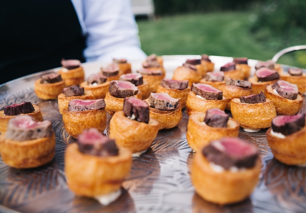 Mini Yorkshire pudding canapés served by waiting staff at wedding.