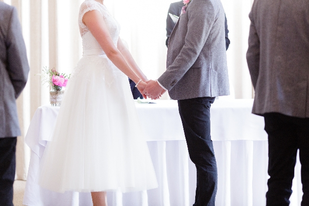 Bride and groom holding hands