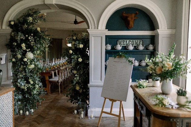 Wedding space at the Painswick adorned in white flowers and foliage