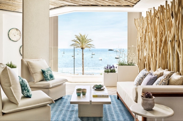 living area in suite hotel room looking out at the sea 