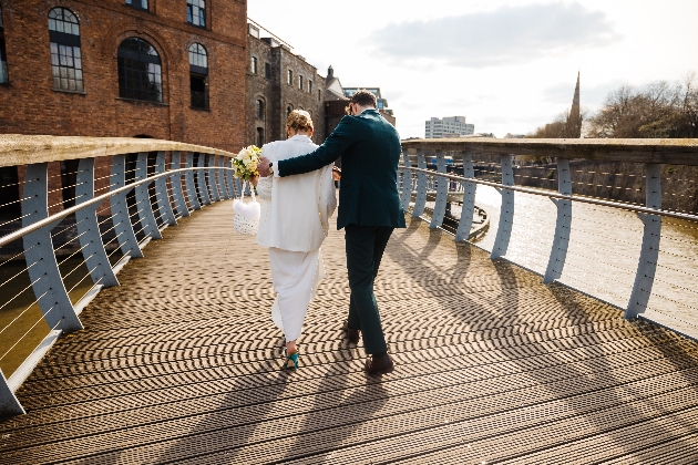 bride and groom strolling along the boardwalk by the wellhead