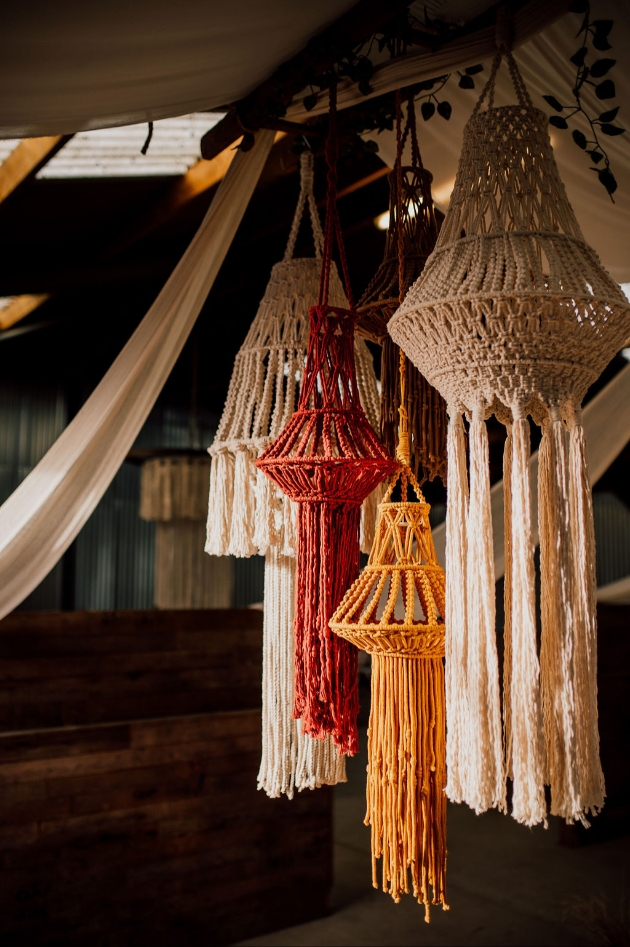 hanging macrame decorations in red, orange and cream - western luxe wedding style