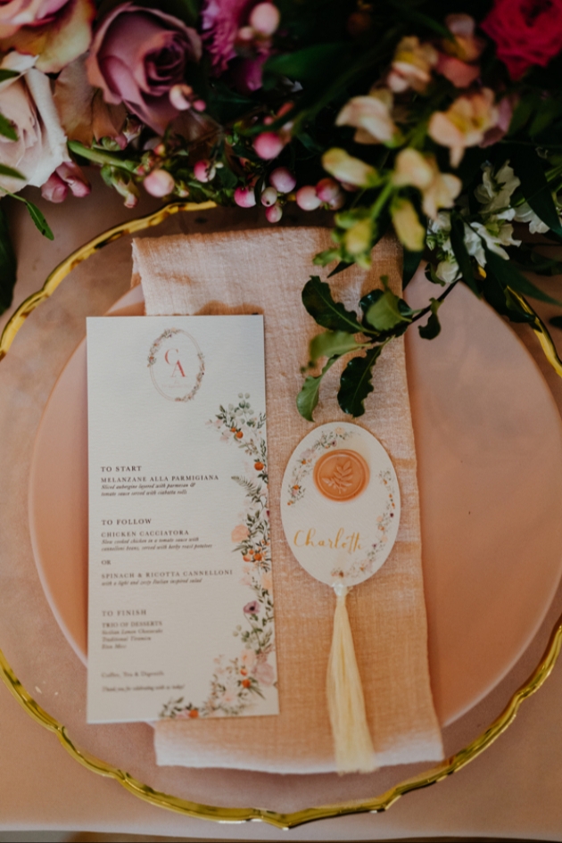 Intimate wedding place setting with peach palette, menu and place name