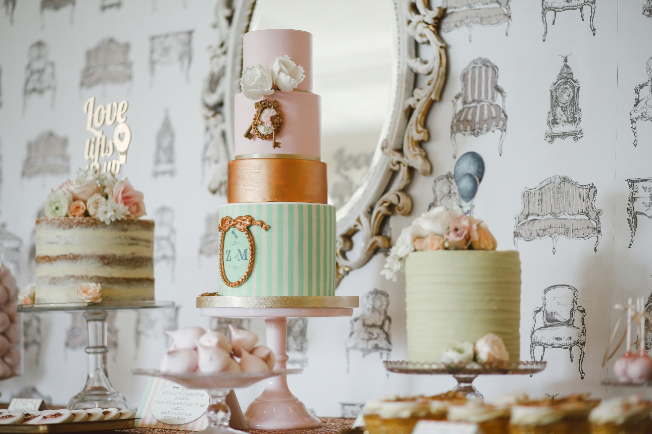 three goregous wedding cakes in a pastel palette of soft green and blush pink
