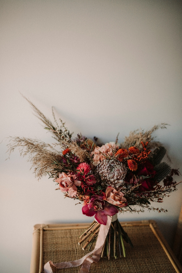 ORCHIDS, STRAWFLOWERS, THISTLE AND WAXFLOWER bouquet
