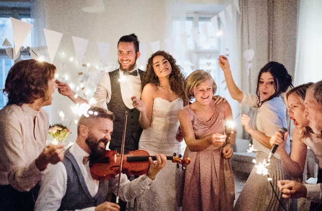 bride and groom celebrating with their guests, violinist and singer