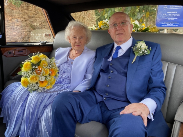 Couple with combined age of 161 in the back of their wedding car on their big day
