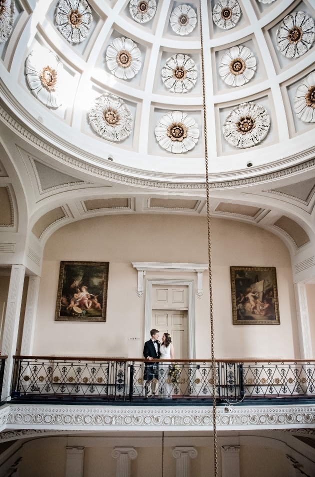 Bride and groom standing on mezzanine at Pittville Pump Room